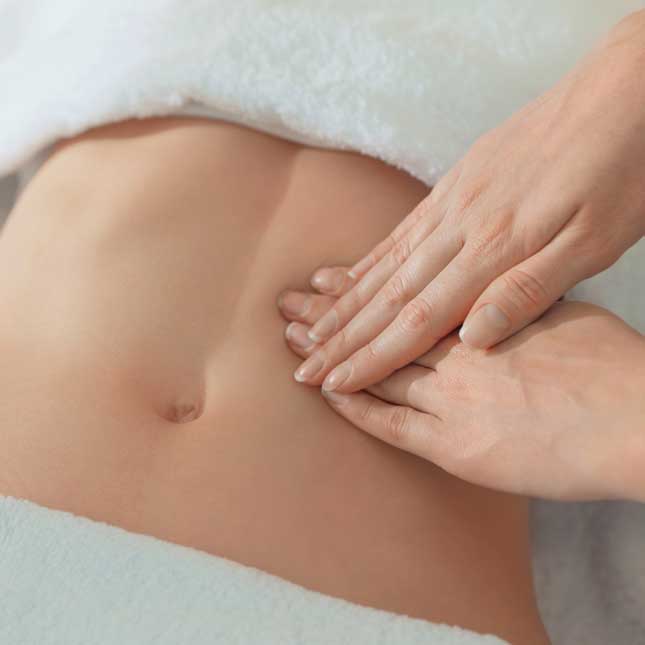 Therapist performing a gentle abdominal massage as part of a Lymphatic Drainage Massage Tysons Corner VA treatment to support circulation, relaxation, and wellness.